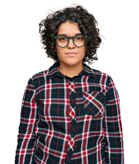 Canvas Print - Young hispanic woman with curly hair wearing casual clothes and glasses with serious expression on face. simple and natural looking at the camera.