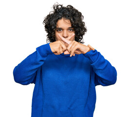 Canvas Print - Young hispanic woman with curly hair wearing turtleneck sweater rejection expression crossing fingers doing negative sign