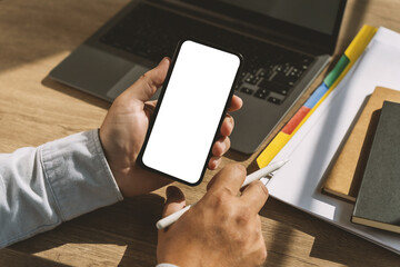 mock up phone in man hand showing white screen Hand with blank cellphone display