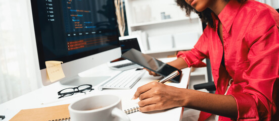 Young working African woman creating coding website developer, thinking data information designer at home office, focusing on laptop Concept of analytical data center in java project job. Tastemaker.