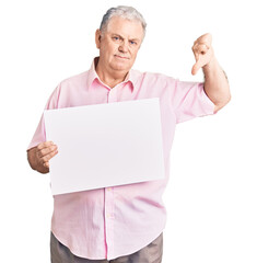 Poster - Senior grey-haired man holding blank empty banner with angry face, negative sign showing dislike with thumbs down, rejection concept