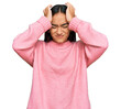 © Krakenimages.com - Young asian woman wearing casual winter sweater suffering from headache desperate and stressed because pain and migraine. hands on head.