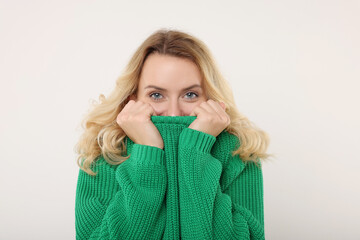 Wall Mural - Beautiful woman in stylish warm sweater on white background