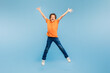 © Prostock-studio - Joyful boy jumping with arms wide open on blue background