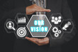 Our vision concept, Business woman hand holding our vision icon on virtual screen.