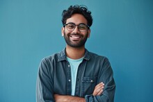 Smiling Confident Arab Young Man, Male Student, Professional Employee Or Programmer Standing Isolated On Blue Background. Happy Handsome Ethnic Guy Wearing Shirt And Glasses, Generative AI 