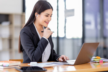 Wall Mural - Asian businessman hand using calculator and working with laptop calculate about finance accounting at workplace.finance accounting concept