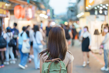 Wall Mural - woman traveler visiting in Taiwan, Tourist with bag sightseeing and Shopping in Shilin Night Market, landmark and popular attractions in Taipei city. Asia Travel and Vacation concept