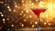  a red cocktail sitting on top of a table next to a golden boke of lights on a dark background.