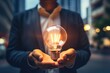 © Wayu - Inspirational thoughts Human hand holds a light bulb for lighting. Ideas for creativity and inspiration for sustainable business development and success generative by ai