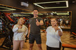 © Odua Images - gym instructor and trainee standing with thumb up gesture in gymnasium