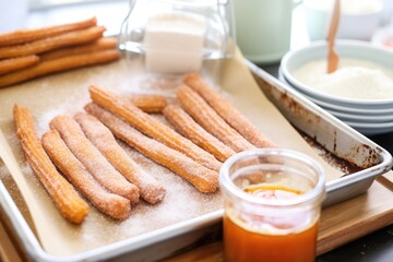 Poster - churros on a baking sheet with cinnamon sugar beside