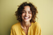 © Synthetica - Portrait of a happy young woman laughing and looking at camera isolated over green background