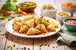 plate of samosas beside ingredients; peas, potatoes and spices