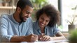 © Sascha - Joyful Young Couple Signing Mortgage Documents: A Celebration of Homeownership and Financial Stability
