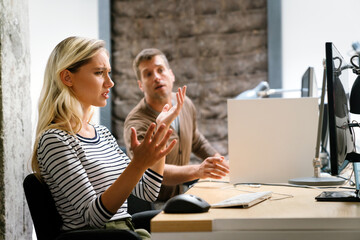 Wall Mural - Portrait of a disappointed woman programmer looking stressed out while working on a computer code