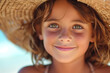 Child portrait of a cute girl in a straw hat on the beach on a summer day, vacation