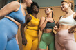 © Westend61 - Happy multiracial female friends standing together in studio