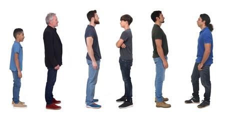 Wall Mural - side view of a group of men of various ages dressed in jeans on white background