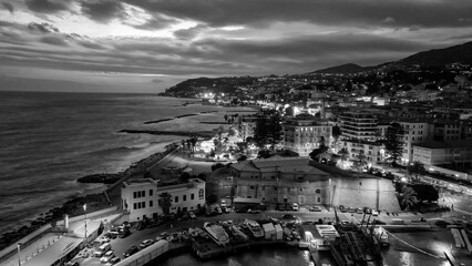 Wall Mural - Aerial view of Sanremo at night, Italy. Port and city buildings