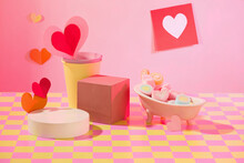 Colorful Marshmallows In Different Shapes Inside A Mini Tub, Paper Cups, Paper Hearts And Platforms On A Pink-yellow Checkered Surface. Empty Podium For Product Display.