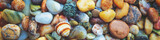 Fototapeta  - Abstract nature pebbles background. Colorful pebbles texture. Stone background. Sea pebble beach. Beautiful nature. Horizontal banner