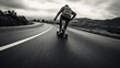 Black and white shot of a guy skating dangerously on the road. Young adult skating through the streets. Modern sports. Proffesional performing a dangerous stunt. Reckless sport.