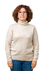 Poster - Beautiful middle ager senior woman wearing turtleneck sweater and glasses over isolated background Relaxed with serious expression on face. Simple and natural looking at the camera.