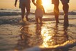 © Fotograf - A family enjoying a peaceful walk on the beach as the sun sets. Perfect for vacation and family-themed designs
