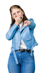 Canvas Print - Beautiful middle age mature woman wearing fashion leather jacket over isolated background Laughing of you, pointing to the camera with finger hand over mouth, shame expression