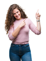 Wall Mural - Beautiful brunette curly hair young girl wearing pink sweater over isolated background smiling and looking at the camera pointing with two hands and fingers to the side.