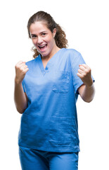 Poster - Young brunette doctor girl wearing nurse or surgeon uniform over isolated background very happy and excited doing winner gesture with arms raised, smiling and screaming for success