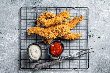 Wall Mural - Dip fried Chicken Steak Fingers strips with  sauces. Gray background. Top view