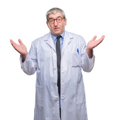 Sticker - Handsome senior doctor, scientist professional man wearing white coat over isolated background clueless and confused expression with arms and hands raised. Doubt concept.