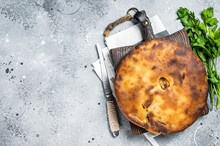 Ossetian Pie With Beef Meat And Herbs On Wooden Board. Gray Background. Top View. Copy Space