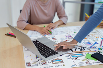 Wall Mural - close up ux developer and ui designer using laptop for brainstorming interface wireframe design. cre