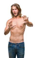 Sticker - Young handsome shirtless man with long hair showing sexy body over isolated background afraid and terrified with fear expression stop gesture with hands, shouting in shock. Panic concept.