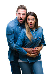 Poster - Young couple in love over isolated background afraid and shocked with surprise expression, fear and excited face.