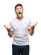© Krakenimages.com - Young handsome man over isolated background crazy and mad shouting and yelling with aggressive expression and arms raised. Frustration concept.