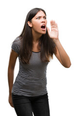 Sticker - Young beautiful hispanic woman shouting and screaming loud to side with hand on mouth. Communication concept.