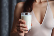 © darshika - Young woman drinks calciumrich milk for strong bones.