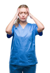 Sticker - Young blonde surgeon doctor woman wearing medical uniform over isolated background suffering from headache desperate and stressed because pain and migraine. Hands on head.