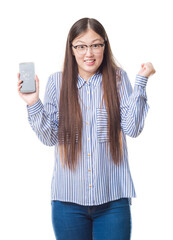 Sticker - Young Chinese woman over isolated background showing broken smartphone screen screaming proud and celebrating victory and success very excited, cheering emotion