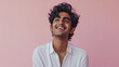 © Amir - Portrait of a smiling Hindu man pink background