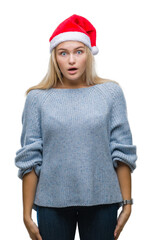 Poster - Young caucasian woman wearing christmas hat over isolated background afraid and shocked with surprise expression, fear and excited face.