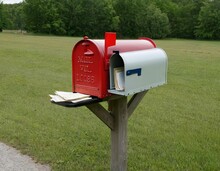 A Rural Mailbox Is Overflowing With An Assortment Of Mail, Including Letters, Bills, And Various Types Of Unsolicited Mail, Indicating Either Neglect Or A Busy Recipient