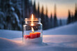 winter candle glowing in a jar , snowy  background