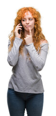 Poster - Young redhead woman talking on the phone serious face thinking about question, very confused idea