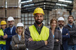 © Halfpoint - Full team of warehouse employees standing in warehouse. Team of workers, managers, female director in modern industrial factory, heavy industry, manufactrury.