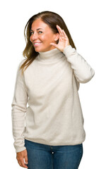 Sticker - Beautiful middle age adult woman wearing winter sweater over isolated background smiling with hand over ear listening an hearing to rumor or gossip. Deafness concept.